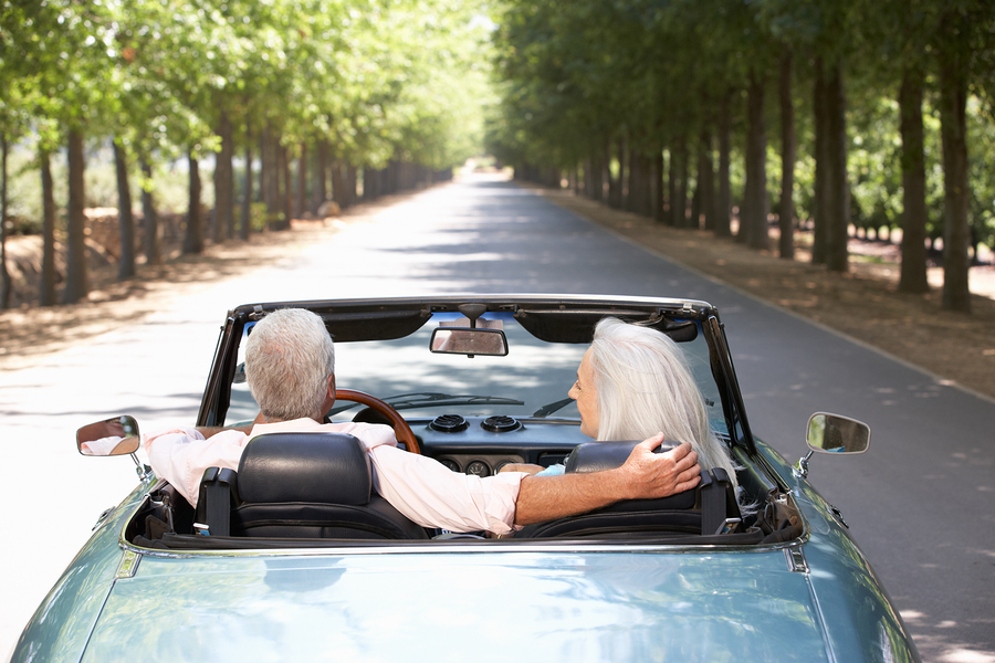 Senior couple in sports car